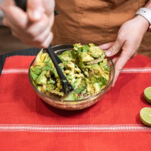 a person making guacamole