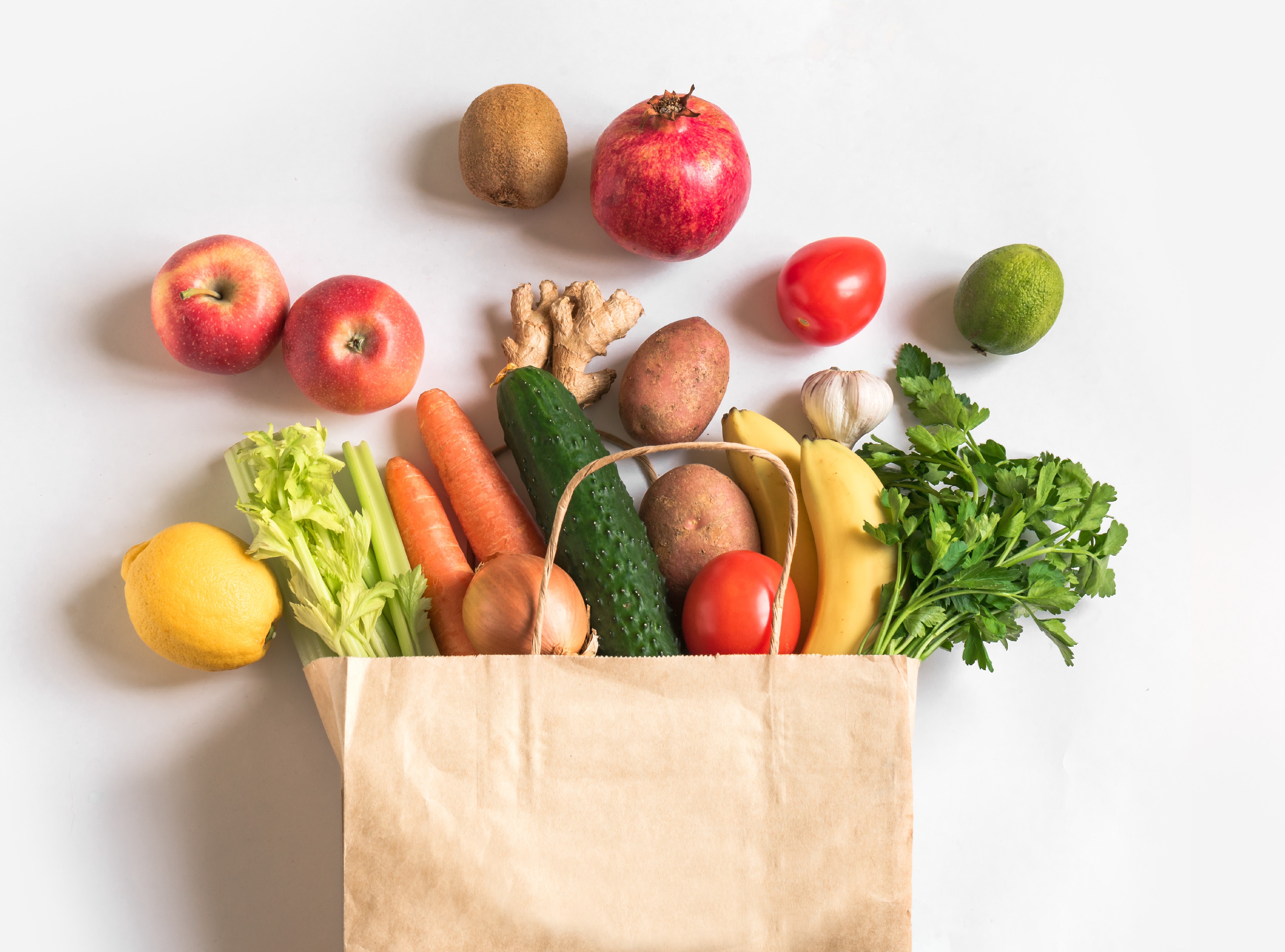 produce overflowing from a grocery bag