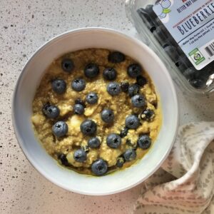 a bowl of oatmeal topped with blueberries
