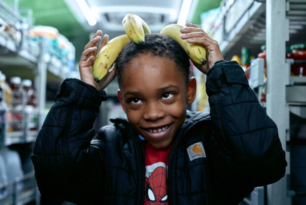 Child enjoying fresh bananas.