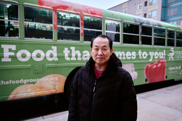 Participant in front of the Food Group bus.