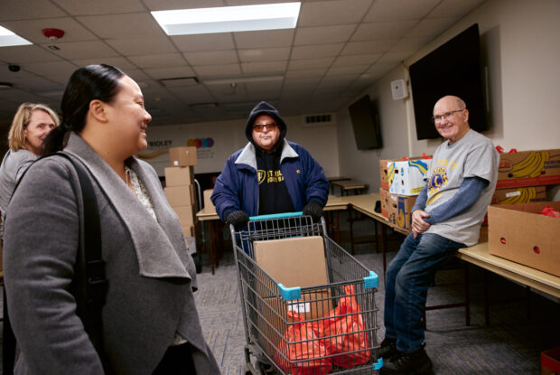 Participant filling cart with fresh groceries.