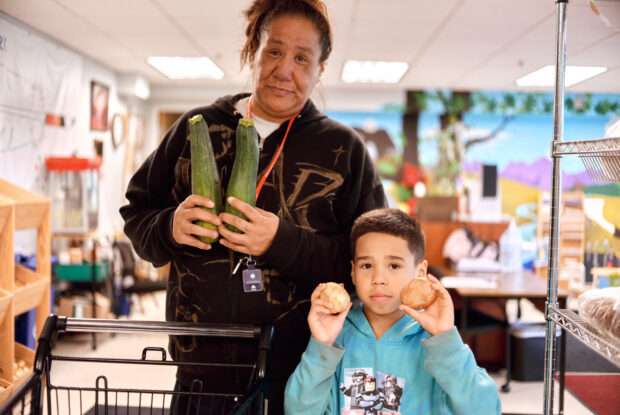 Participant parent and child selecting fresh veggies.