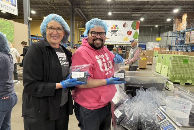 Group of volunteers preparing bags of black beans.