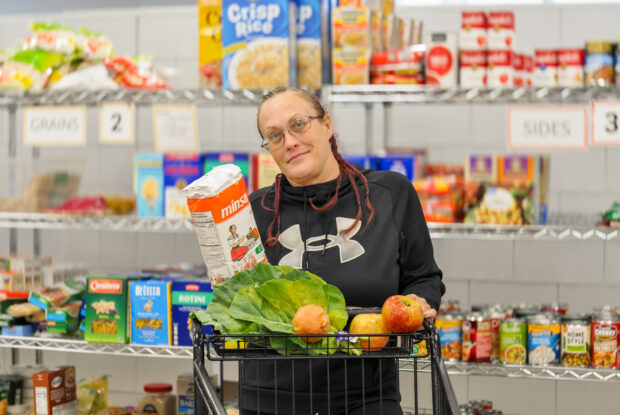 Participant with a selection of fresh fruits and veggies.