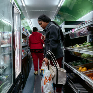 young person shops for groceries on the Twin Cities Mobile Market bus