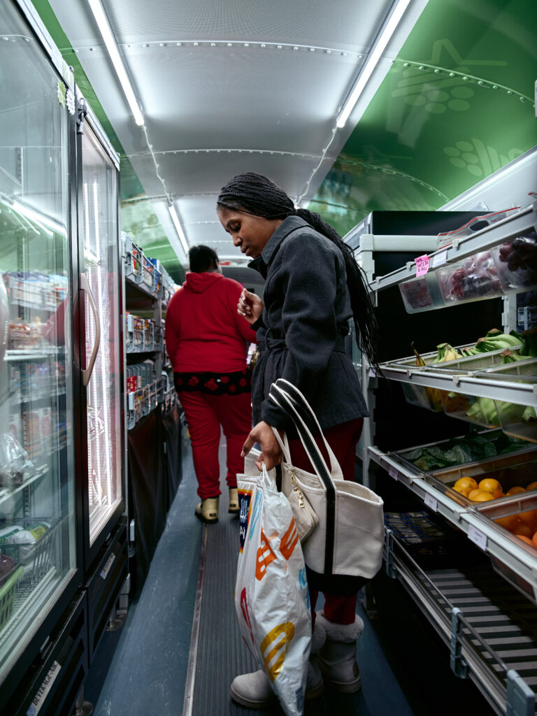 young person shops for groceries on the Twin Cities Mobile Market bus
