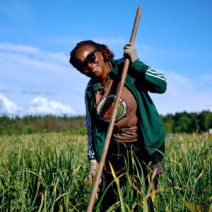 Farmer stands with shovel at Big River Farms