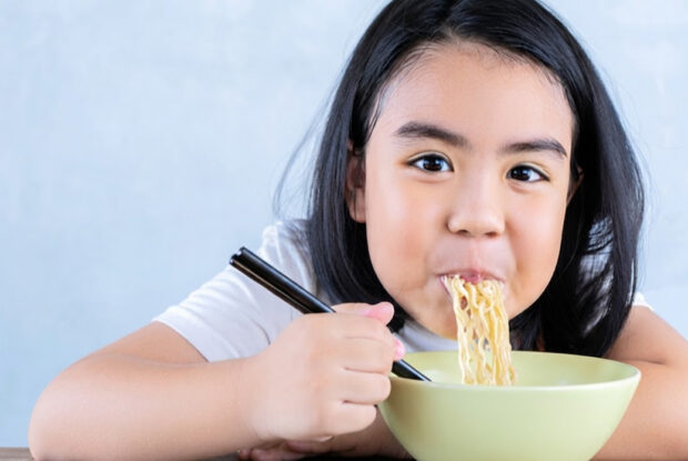 Girl eating noodles