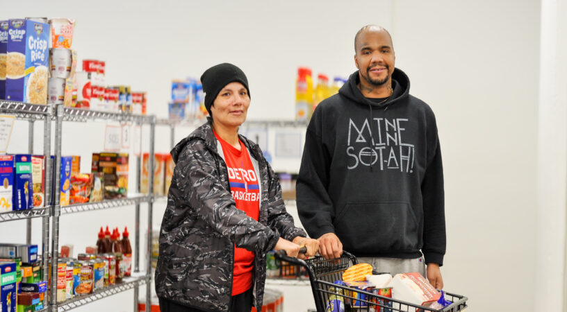 Man and woman participant shopping at food shelf.