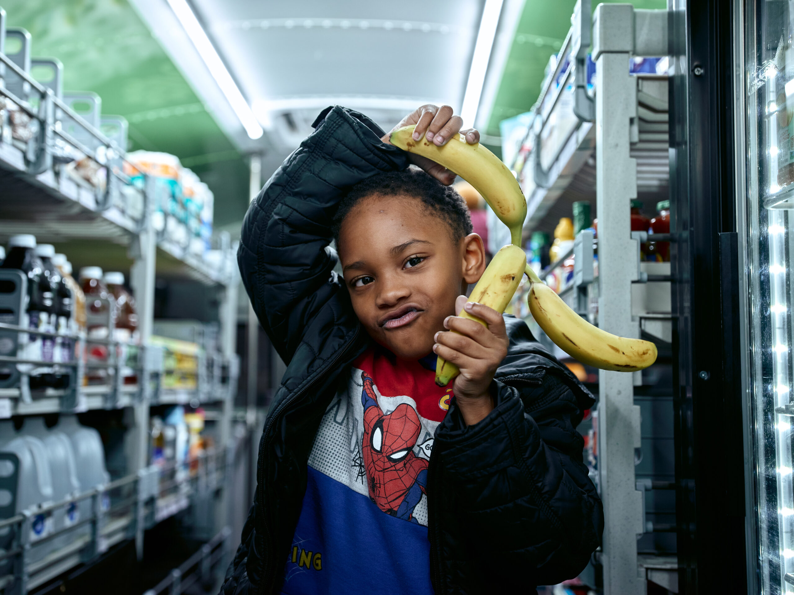 Boy shopping on Twin Cities Mobile Market bus.
