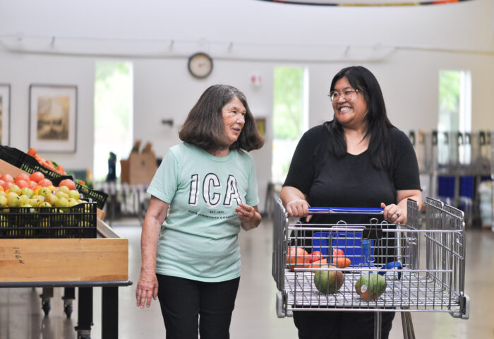 ICA volunteer shopping with food shelf participant.